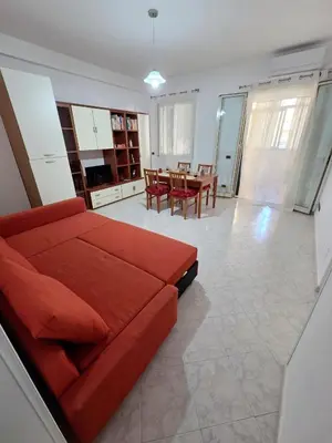 a living room with a red couch and a table at Casa Pino in Isola delle Femmine