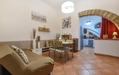 a living room with a couch and a table at Nice Home In Capaci With Wifi in Capaci