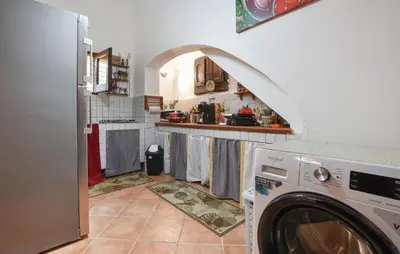 a kitchen with a washing machine in a kitchen at Nice Home In Capaci With Wifi in Capaci