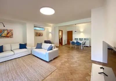 a living room with a white couch and a table at Solemar Sicilia - Villa Alma in Palermo