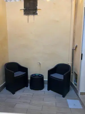 two chairs and a table in a room at Oasi house in Palermo