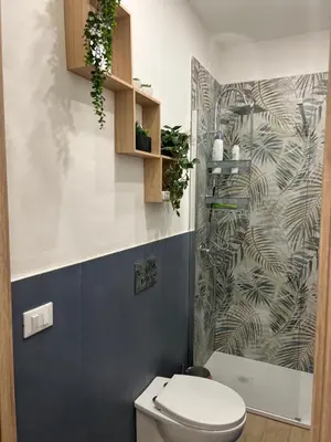 a bathroom with a toilet and a shower at Oasi house in Palermo