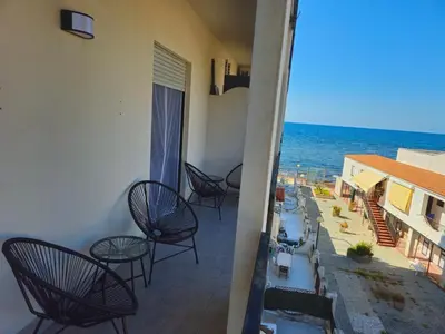 a balcony with chairs and a view of the ocean at CasAmare - private parking in Carini