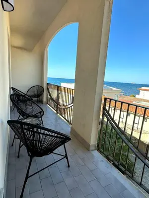 a balcony with chairs and a view of the ocean at CasAmare - private parking in Carini