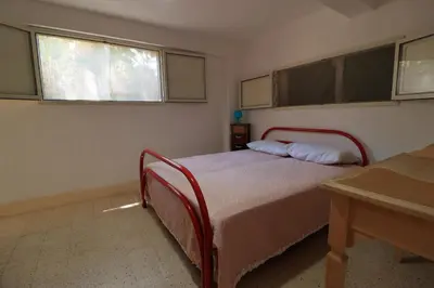 a bedroom with a bed and two windows at Villa Barbera - Terrace overlooking the sea in Bagheria