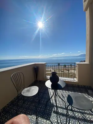a balcony with chairs and a view of the ocean at PHI-Lampara in Santa Flavia