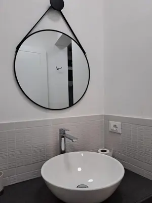 a bathroom with a sink and a mirror on the wall at PHI-Lampara in Santa Flavia