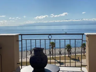 a vase sitting on a balcony looking at the beach at PHI-Lampara in Santa Flavia