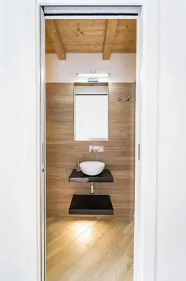 a bathroom with a sink and a mirror at Casa Clio - Mondello Home in Palermo