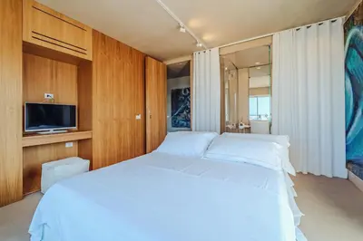 a bedroom with two beds and a flat screen tv at Hybrid Icon Rooms Gallery in Palermo