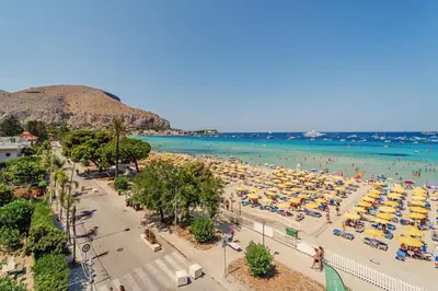 a balcony with a view of the beach at Hybrid Icon Rooms Gallery in Palermo