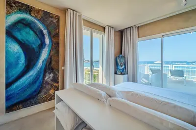 a bedroom with a large bed and a large window at Hybrid Icon Rooms Gallery in Palermo