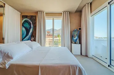 a bedroom with a white bed and a large window at Hybrid Icon Rooms Gallery in Palermo