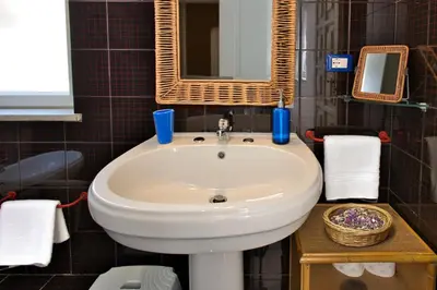 a bathroom with a white sink and a mirror at VFH Villa Cala del Cuore con piscina, 50 m dal mare in Santa Flavia