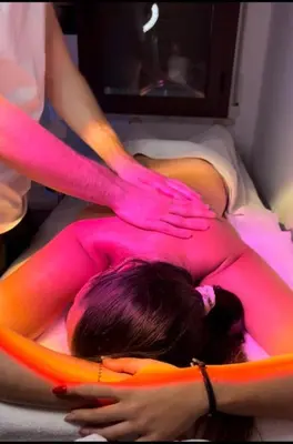 a woman laying on a bed covered in pink dye at VFH Villa Cala del Cuore con piscina, 50 m dal mare in Santa Flavia