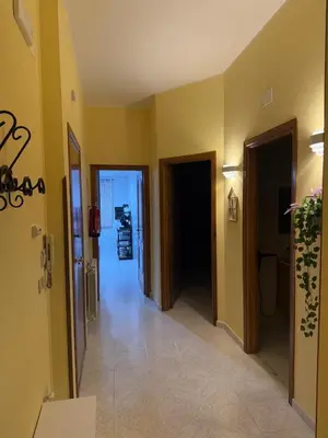 a hallway of a building with yellow walls at Lucy home in Palermo