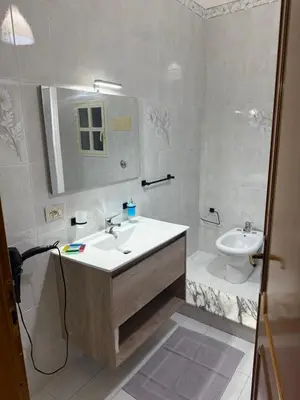 a white bathroom with a sink and a toilet at Lucy home in Palermo