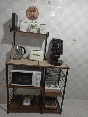 a shelf with a microwave and other appliances on it at Lucy home in Palermo