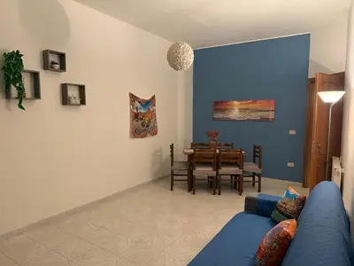 a living room with a blue couch and a table at Lucy home in Palermo