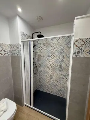 a bedroom with a large bed and a bathroom at nuova oreto stazione rooms in Palermo