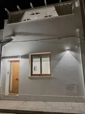 a house with two windows on the side of it at Damasa House in Balestrate