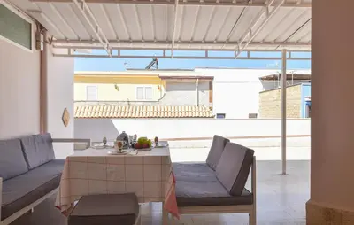 a living room with a table and chairs and a large window at Amazing Apartment In Trappeto With Wifi in Trappeto