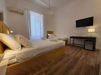 a bedroom with a large bed and a television at Dolce Dormire in Palermo