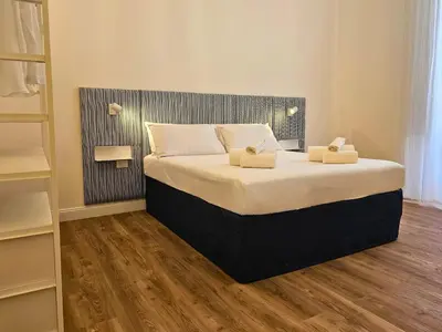 a bedroom with a bed with two pillows on it at Dolce Dormire in Palermo