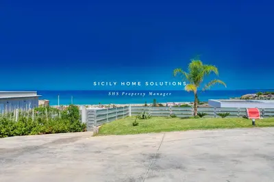 a house with a sign that reads safely home solutions sits happy memory at Appartamento in villa vista mare con jacuzzi By Sicily Home Solutions in Balestrate