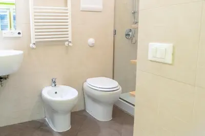 a bathroom with a toilet and a sink at 4Quarti in Palermo