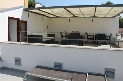 an outdoor patio with a table and chairs at b&b Simpaty in Mondello