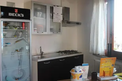 a kitchen with a sink and a stove and a refrigerator at b&b Simpaty in Mondello