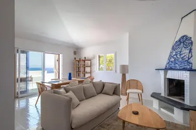 a living room with a couch and a fireplace at Sea Frame Design Apartments with Pool by Wonderful Italy in Santa Flavia