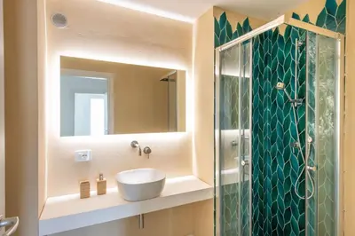 a bathroom with a sink and a glass shower at Sea Frame Design Apartments with Pool by Wonderful Italy in Santa Flavia