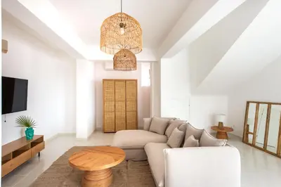 a living room with a couch and a table at Sea Frame Design Apartments with Pool by Wonderful Italy in Santa Flavia