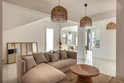 a living room with a couch and a table at Sea Frame Design Apartments with Pool by Wonderful Italy in Santa Flavia