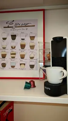 a microwave and a coffee cup on a shelf at Qanat House con Terrazzo Privato in Palermo