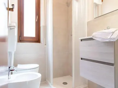 a bathroom with a toilet and a sink and a shower at Vue Merveilleuse Apartment in Castellammare del Golfo