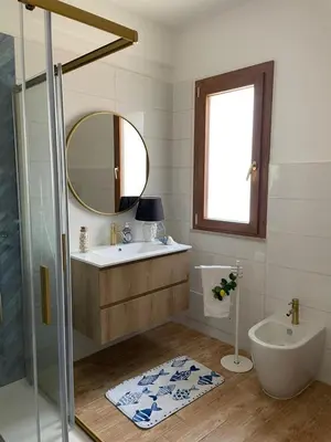 a bathroom with a sink and a tub and a mirror at La Casa dei Limoni - Your Sicilian Getaway near the sea in Terrasini in Terrasini