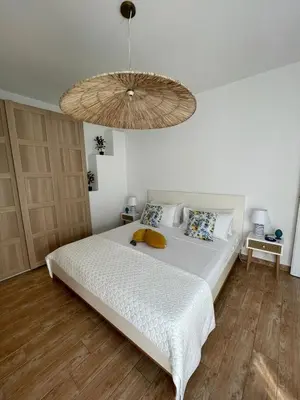a bedroom with a large white bed with a large chandelier at La Casa dei Limoni - Your Sicilian Getaway near the sea in Terrasini in Terrasini