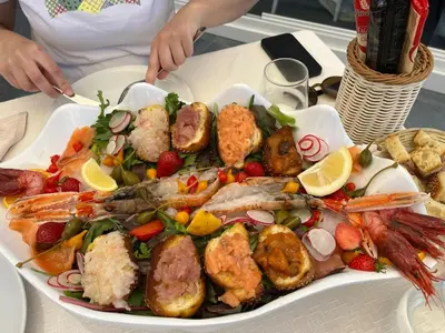 a plate of food with seafood on a table at Casa Mulinazzo in Cinisi