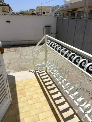 a metal bench sitting on top of a balcony at Casa Mini' in Palermo