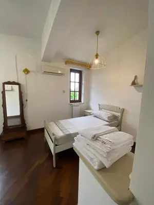 two beds in a room with a mirror at Casa Mini' in Palermo