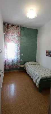 a bedroom with a bed and a window at Airoldi Home in Palermo