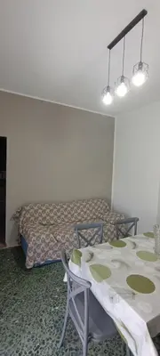 a room with a bed and a table and chairs at Airoldi Home in Palermo
