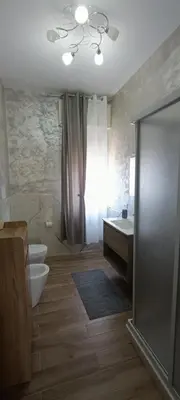 a bathroom with a toilet and a sink and a shower at Airoldi Home in Palermo