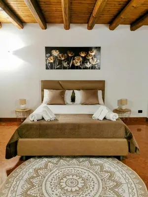 a bedroom with a large bed with two tables at Bellini al Massimo in Palermo