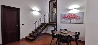 a room with a staircase with a table and chairs at Bellini al Massimo in Palermo