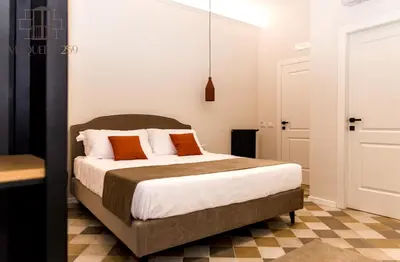 a bedroom with a bed with orange and white pillows at Maqueda 259 - In Palermo's Lively Heart in Palermo