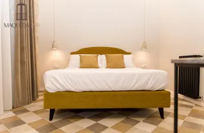 a bedroom with a bed with white sheets and pillows at Maqueda 259 - In Palermo's Lively Heart in Palermo